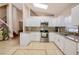 Bright kitchen with white cabinets, granite countertops, tile backsplash, stainless steel appliances and tile flooring at 4381 Creekside Blvd, Kissimmee, FL 34746