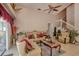 Elegant living room featuring two sofas, a ceiling fan, and a staircase at 4381 Creekside Blvd, Kissimmee, FL 34746
