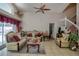 Elegant living room featuring two sofas, a ceiling fan, and a staircase at 4381 Creekside Blvd, Kissimmee, FL 34746
