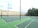 Community basketball and tennis courts surrounded by a high fence at 455 Wymore Rd # 203, Altamonte Springs, FL 32714