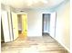 Bedroom with wood-look floors; doorway to laundry area visible at 455 Wymore Rd # 203, Altamonte Springs, FL 32714