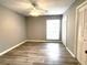 Cozy bedroom with ceiling fan, window, and wood-look flooring at 455 Wymore Rd # 203, Altamonte Springs, FL 32714