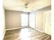 Bedroom features a ceiling fan, neutral paint, and wood-look flooring at 455 Wymore Rd # 203, Altamonte Springs, FL 32714