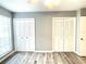 Bedroom featuring wood-look floors and dual closets at 455 Wymore Rd # 203, Altamonte Springs, FL 32714