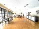 Bright common area with parquet floors, tables, chairs, and large windows at 455 Wymore Rd # 203, Altamonte Springs, FL 32714