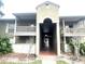 Inviting condo complex with central walkway, balconies, and mature landscaping at 455 Wymore Rd # 203, Altamonte Springs, FL 32714