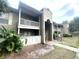 Condo complex featuring private balconies, neutral paint, and lush landscaping at 455 Wymore Rd # 203, Altamonte Springs, FL 32714