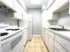 Bright kitchen features white appliances, light countertops, and tile flooring at 455 Wymore Rd # 203, Altamonte Springs, FL 32714