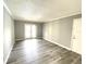 Bright living room with neutral walls and modern vinyl plank flooring at 455 Wymore Rd # 203, Altamonte Springs, FL 32714