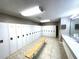 Community locker room with multiple lockers, sink and mirror, and a bench at 455 Wymore Rd # 203, Altamonte Springs, FL 32714
