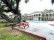 Inviting pool area with BBQ grills and picnic tables for outdoor gatherings and enjoyment at 455 Wymore Rd # 203, Altamonte Springs, FL 32714
