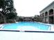 Community pool surrounded by lush landscaping, offering a refreshing oasis for residents at 455 Wymore Rd # 203, Altamonte Springs, FL 32714