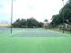 Community tennis courts bordered by trees and a building at 455 Wymore Rd # 203, Altamonte Springs, FL 32714