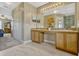 Large bathroom features a double sink vanity, a large mirror, and tiled floors at 4574 Ficus Tree Rd, Kissimmee, FL 34758