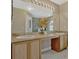 Bathroom featuring a double sink vanity with a large mirror and contemporary lighting at 4574 Ficus Tree Rd, Kissimmee, FL 34758