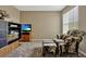 Cozy bedroom featuring carpet flooring, comfortable seating, and a media center for entertainment at 4574 Ficus Tree Rd, Kissimmee, FL 34758