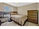 Cozy bedroom with a comfortable bed, dresser, and a window with natural light at 4574 Ficus Tree Rd, Kissimmee, FL 34758