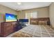 Bedroom featuring a double bed, matching furniture, and a flat-screen TV, creating a cozy and inviting atmosphere at 4574 Ficus Tree Rd, Kissimmee, FL 34758