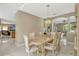 Bright dining room with chandelier and marble flooring open to living spaces at 4574 Ficus Tree Rd, Kissimmee, FL 34758