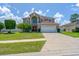 Charming two-story home with manicured lawn, large driveway and beautiful landscaping at 4574 Ficus Tree Rd, Kissimmee, FL 34758