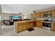 Open-concept kitchen and living area with modern appliances, wood cabinets, and ample counter space, perfect for entertaining at 4574 Ficus Tree Rd, Kissimmee, FL 34758