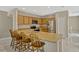 The kitchen has an eat-in counter, stainless appliances, and neutral cabinetry, leading to the dining area at 4574 Ficus Tree Rd, Kissimmee, FL 34758