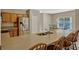 Kitchen with granite countertops, stainless steel refrigerator and bar top seating at 4574 Ficus Tree Rd, Kissimmee, FL 34758