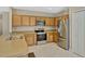 Modern kitchen featuring stainless steel appliances, granite countertops, and ample wood cabinetry at 4574 Ficus Tree Rd, Kissimmee, FL 34758