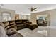 Spacious living room with modern marble flooring, ceiling fan, and abundant natural light at 4574 Ficus Tree Rd, Kissimmee, FL 34758