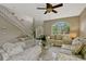 Open-concept living room featuring staircase, comfortable seating and bright front door at 4574 Ficus Tree Rd, Kissimmee, FL 34758