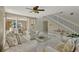 Bright living room features neutral-toned decor, tiled floors, staircase, and an archway leading to the dining room at 4574 Ficus Tree Rd, Kissimmee, FL 34758