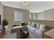 Comfortable living area featuring neutral colors, carpet, and a large sectional sofa at 4574 Ficus Tree Rd, Kissimmee, FL 34758