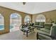Enclosed patio area with comfortable seating, a view of the pool, and multiple entryways at 4574 Ficus Tree Rd, Kissimmee, FL 34758
