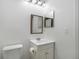 This bathroom features a toilet, a vanity with a mirror, and neutral paint at 4584 Pheasant Run Dr # B, Orlando, FL 32808