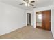 Bedroom with carpeted floor, a ceiling fan, and a sliding closet with mirrors at 4584 Pheasant Run Dr # B, Orlando, FL 32808