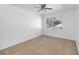 This bedroom features neutral carpet and a window with blinds at 4584 Pheasant Run Dr # B, Orlando, FL 32808
