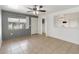 Bright living room with neutral tile flooring, a ceiling fan and a view to the dining area at 4584 Pheasant Run Dr # B, Orlando, FL 32808