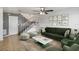 Staged living room showcasing a green sofa, area rug, and modern décor at 4584 Pheasant Run Dr # B, Orlando, FL 32808