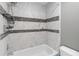 This shower features gray and white tile and an adjustable shower head at 4584 Pheasant Run Dr # B, Orlando, FL 32808