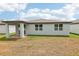 Exterior view of the home with covered patio and partially dry lawn at 4713 Jasmine Cir, Leesburg, FL 34748