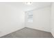 This room features carpeted flooring, neutral colored walls, and a window with coverings at 4713 Jasmine Cir, Leesburg, FL 34748