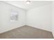 Cozy bedroom features carpet and a window with blinds at 4713 Jasmine Cir, Leesburg, FL 34748