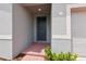 Inviting entryway with a gray front door and brick steps leading to the home at 4713 Jasmine Cir, Leesburg, FL 34748