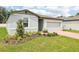 Attractive single-story home with a brick driveway and attached two-car garage at 4713 Jasmine Cir, Leesburg, FL 34748