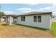 Home exterior with covered patio and spacious backyard on a sunny day at 4713 Jasmine Cir, Leesburg, FL 34748