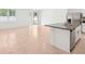 Open floor plan, kitchen with a center island, stainless appliances, and sliding glass doors at 4713 Jasmine Cir, Leesburg, FL 34748