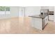 Modern kitchen featuring a central island with a sink and stainless steel appliances at 4713 Jasmine Cir, Leesburg, FL 34748