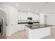 Bright kitchen features stainless appliances, a center island, and lots of white cabinet storage at 4713 Jasmine Cir, Leesburg, FL 34748