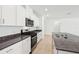 Modern kitchen with stainless steel appliances and white cabinetry at 4713 Jasmine Cir, Leesburg, FL 34748
