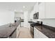 Well-equipped kitchen with stainless appliances, white cabinets, and a central island with a sink at 4713 Jasmine Cir, Leesburg, FL 34748